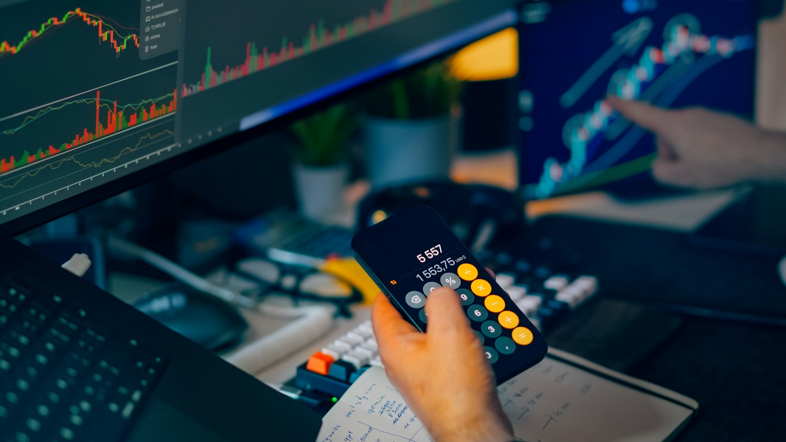 Trader analysing market charts and calculating risk